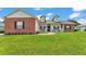 Charming home featuring a front porch, brick accents, dormer windows, and a well-maintained green lawn at 5579 Summerland Hills Dr, Lakeland, FL 33812