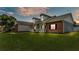 Charming single-Gathering home showcasing a well-manicured lawn and inviting front porch at 5579 Summerland Hills Dr, Lakeland, FL 33812