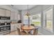 Cozy breakfast nook with a round wooden table and natural light from adjacent windows illuminating the space at 5579 Summerland Hills Dr, Lakeland, FL 33812
