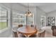 Bright breakfast nook featuring a round wooden table with a view of the pool area, perfect for casual dining at 5579 Summerland Hills Dr, Lakeland, FL 33812