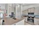 Modern kitchen with stainless steel appliances and a breakfast bar, perfect for casual dining and entertaining at 5579 Summerland Hills Dr, Lakeland, FL 33812
