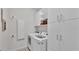 Bright laundry room with white washer, dryer, cabinets, shelving and minimalist decor at 5579 Summerland Hills Dr, Lakeland, FL 33812