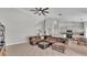 Bright living room connects to the kitchen with a breakfast nook, has a large sectional sofa and tile flooring at 5579 Summerland Hills Dr, Lakeland, FL 33812