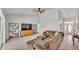 Open-concept living room with a plush sectional sofa, vaulted ceilings and a stylish entertainment center at 5579 Summerland Hills Dr, Lakeland, FL 33812