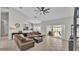 Spacious living room seamlessly connects to the kitchen, featuring a comfortable sectional sofa and modern decor at 5579 Summerland Hills Dr, Lakeland, FL 33812