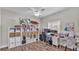 Bright office with wood floors, large shelving, desk, dual monitors, and natural light from the window at 5579 Summerland Hills Dr, Lakeland, FL 33812