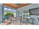 This screened patio has comfortable lounge furniture, and has sliding glass doors that lead to the beautiful in-ground swimming pool at 5579 Summerland Hills Dr, Lakeland, FL 33812