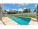 This beautiful in-ground swimming pool is surrounded by a screened enclosure and has a clean, well-manicured backyard at 5579 Summerland Hills Dr, Lakeland, FL 33812