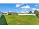 Expansive backyard with lush green grass and privacy fence, offering plenty of room for outdoor activities at 577 Majestic Gardens Blvd, Winter Haven, FL 33880