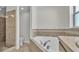 Bathroom featuring a separate shower and soaking tub with tile surround at 577 Majestic Gardens Blvd, Winter Haven, FL 33880