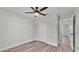 Cozy bedroom with wood-look flooring, ceiling fan, closet, and neutral walls at 577 Majestic Gardens Blvd, Winter Haven, FL 33880
