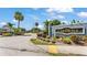 The Gardens entrance sign amidst lush landscaping and palm trees on a bright, sunny day at 577 Majestic Gardens Blvd, Winter Haven, FL 33880