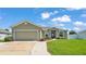 Charming single-story home with a well-manicured lawn, inviting entryway, and a spacious two-car garage at 577 Majestic Gardens Blvd, Winter Haven, FL 33880
