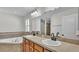 Elegant bathroom featuring dual sinks, soaking tub, and tiled accents for a luxurious experience at 577 Majestic Gardens Blvd, Winter Haven, FL 33880