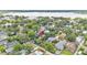 Aerial view of property showcasing its location surrounded by lush greenery and a nearby lake at 608 Finney St, Lakeland, FL 33803