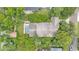 Aerial view displaying a secluded pool and patio, surrounded by mature landscaping for ultimate privacy at 608 Finney St, Lakeland, FL 33803