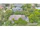 An aerial view showcases a backyard pool and lush landscaping creating a private oasis at 608 Finney St, Lakeland, FL 33803