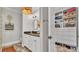 Bathroom with dual sinks, walk-in closet with custom shelving, and granite countertops at 608 Finney St, Lakeland, FL 33803