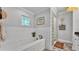 A modern bathroom with a soaking tub and separate glass block shower, offering a serene and luxurious experience at 608 Finney St, Lakeland, FL 33803