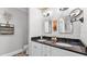 Elegant bathroom with dual sinks, black granite countertops, and modern fixtures at 608 Finney St, Lakeland, FL 33803