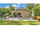 Charming backyard features a pristine pool, lush greenery, and inviting outdoor seating at 608 Finney St, Lakeland, FL 33803