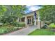 Charming home showcasing a lovely landscaped front yard, covered porch, and inviting blue front door at 608 Finney St, Lakeland, FL 33803