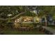 Inviting home featuring a landscaped garden, covered porch with string lights, and a welcoming entryway at 608 Finney St, Lakeland, FL 33803