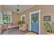 Charming front porch with swing, seating, a bright blue door, and decorative details at 608 Finney St, Lakeland, FL 33803
