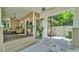 Cozy front porch features a swing, seating, decorative tile steps, and a view of the carport at 608 Finney St, Lakeland, FL 33803