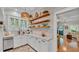 Charming kitchen features open shelving, white cabinets, and stainless steel appliances at 608 Finney St, Lakeland, FL 33803