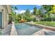 Backyard featuring a pool, lush landscaping, and a shed at 608 Finney St, Lakeland, FL 33803