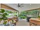Inviting covered porch with an outdoor kitchen, comfortable seating, and lush landscaping at 608 Finney St, Lakeland, FL 33803
