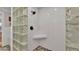 Clean shower with glass block wall, pebble floor, rain shower head, and corner shelf at 608 Finney St, Lakeland, FL 33803