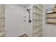 Modern shower featuring glass block wall, rain shower head, and built-in shelving at 608 Finney St, Lakeland, FL 33803