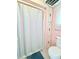 Bathroom with shower and pink color scheme at 622 Elizabeth Ln, Lakeland, FL 33809