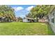 Expansive backyard featuring green grass, a shed, and lush trees at 640 Forrest Dr, Bartow, FL 33830