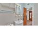 A bathroom featuring a sink, medicine cabinet, mirror, and a view into an adjacent room at 640 Forrest Dr, Bartow, FL 33830