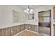 Dining room with wood paneling, tile flooring, and a view into another room at 640 Forrest Dr, Bartow, FL 33830