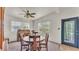 Bright dining room with large windows and classic wooden furniture at 640 Forrest Dr, Bartow, FL 33830