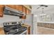 Kitchen view showcasing the range oven, refrigerator, and view into the dining area at 640 Forrest Dr, Bartow, FL 33830