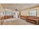 Living room with wood paneling, carpeting, and natural light from windows at 640 Forrest Dr, Bartow, FL 33830