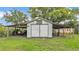 Backyard shed with awning for storage, featuring double doors at 640 Forrest Dr, Bartow, FL 33830