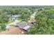 Community aerial view of a home surrounded by lush trees and a lake nearby at 6406 Butternut Dr, Lakeland, FL 33813