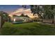 A backyard showcasing a large, screened-in pool area with ample green space surrounding it at 6406 Butternut Dr, Lakeland, FL 33813
