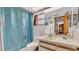 Bathroom featuring tile countertop, toilet, and shower with blue curtain at 6406 Butternut Dr, Lakeland, FL 33813
