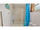 Bathroom featuring tile walls, showerhead, and blue patterned shower curtain at 6406 Butternut Dr, Lakeland, FL 33813
