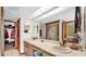 A full bathroom with double sinks, tile floor and walk-in shower at 6406 Butternut Dr, Lakeland, FL 33813