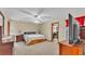 A carpeted main bedroom featuring a ceiling fan, closet and neutral colored walls at 6406 Butternut Dr, Lakeland, FL 33813