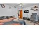 Bright bedroom with ceiling fan, television, and quirky baseball themed decor at 6406 Butternut Dr, Lakeland, FL 33813