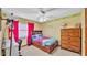 Bright bedroom with a decorative wallpaper border and large wooden dresser at 6406 Butternut Dr, Lakeland, FL 33813